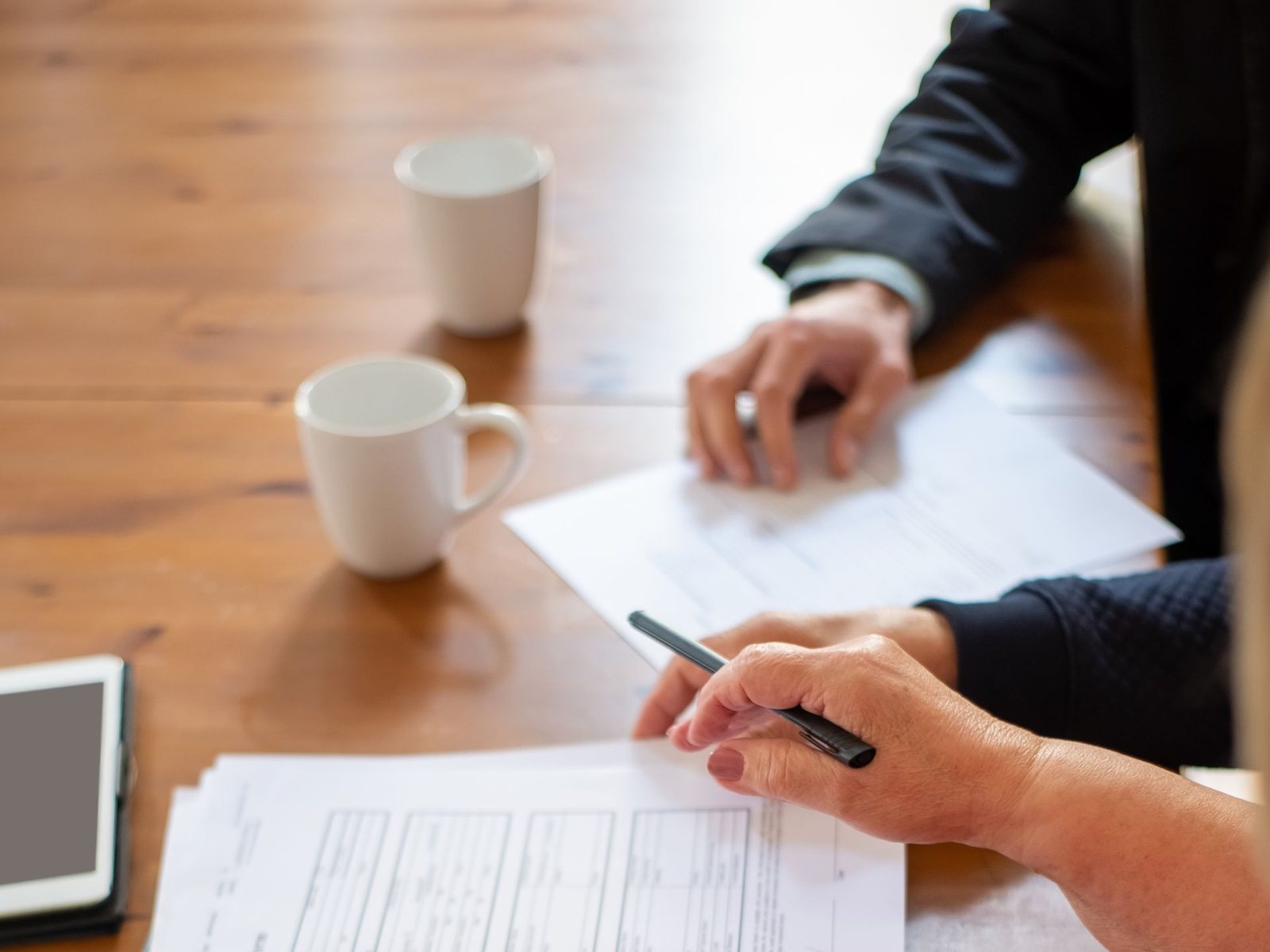 Team member reviewing a submitted form at a conference table