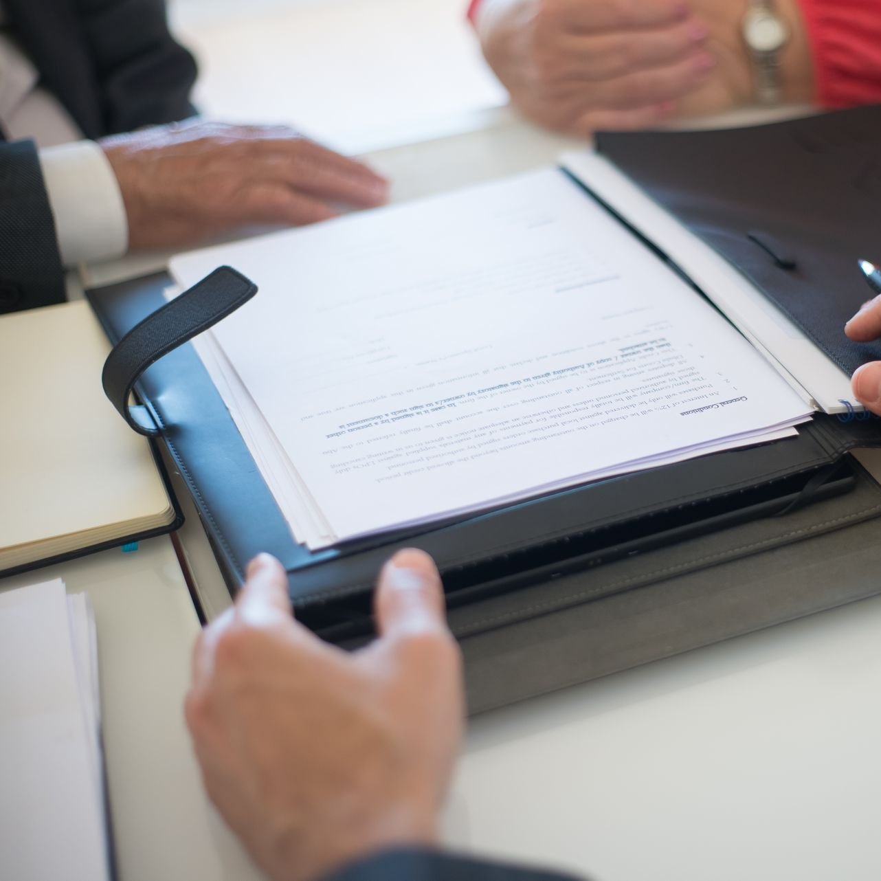 Open folder of property documents held between attorney and client