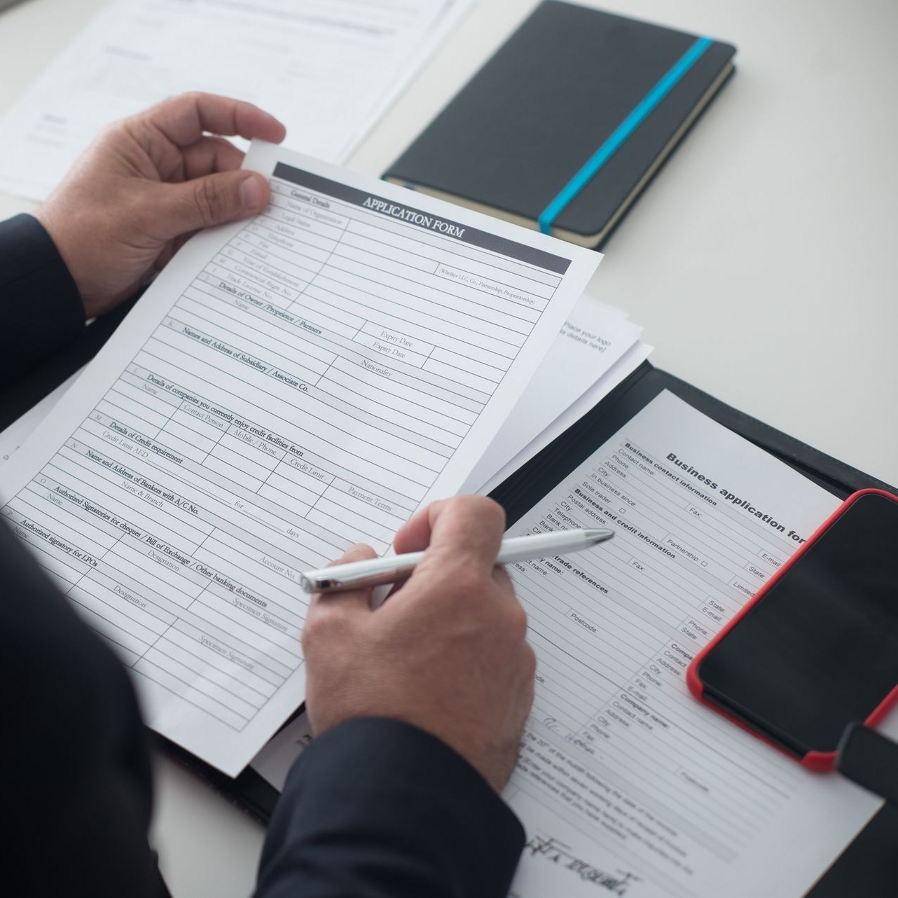Court request forms being filled in inside an open folder
