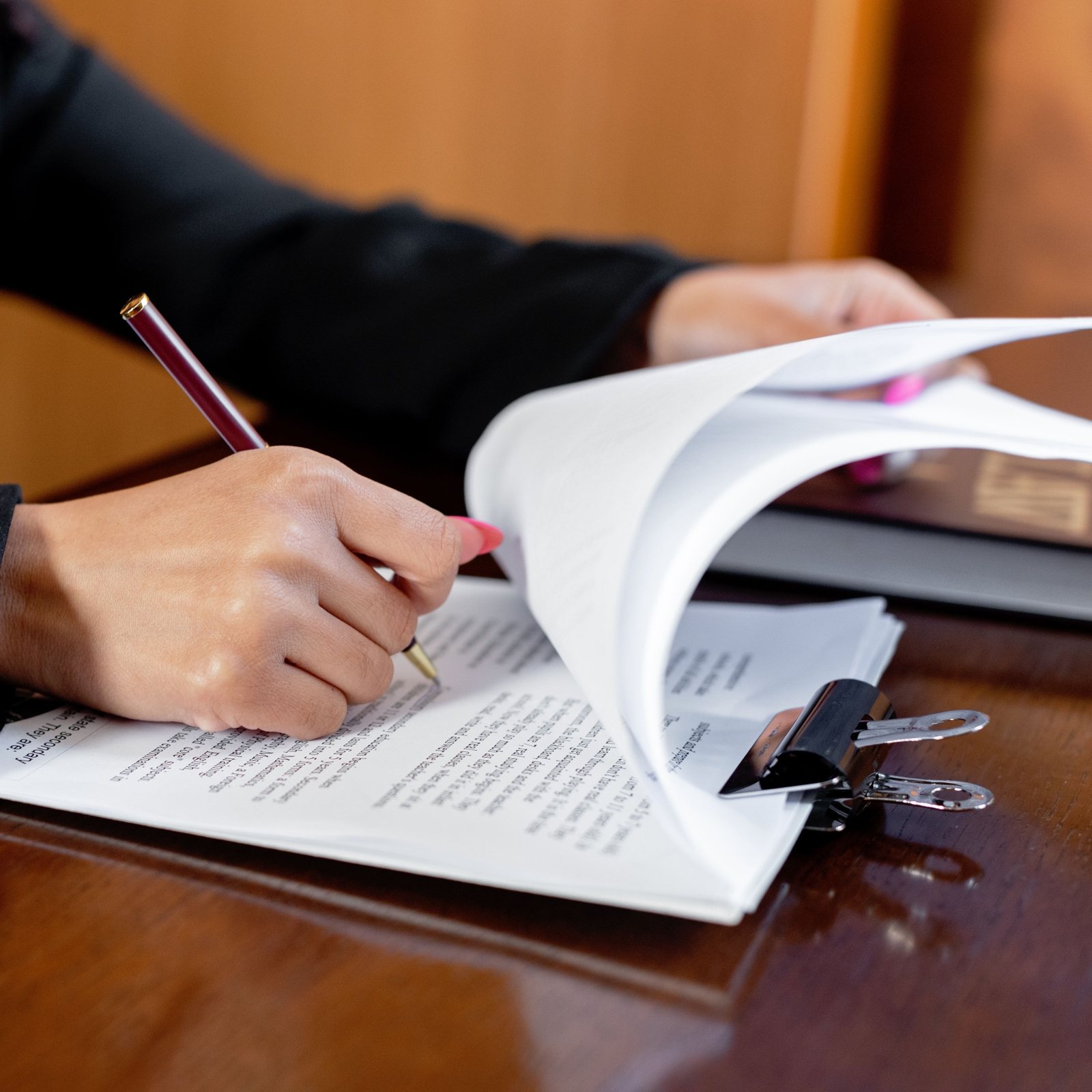 Estate planning documents and a pen on a wooden desk